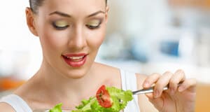 A beautiful slender girl eating healthy food